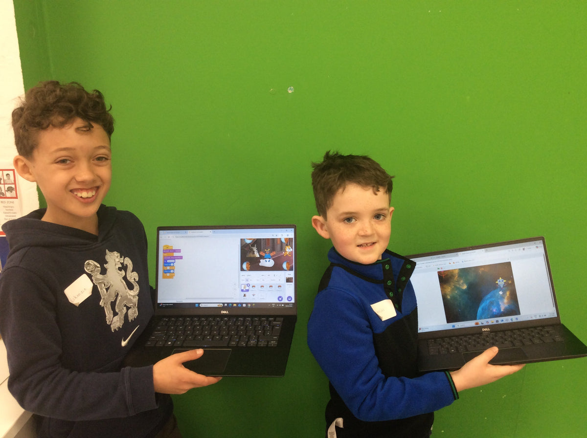 Child coding a game in Scratch at a BetaGen after-school coding club.