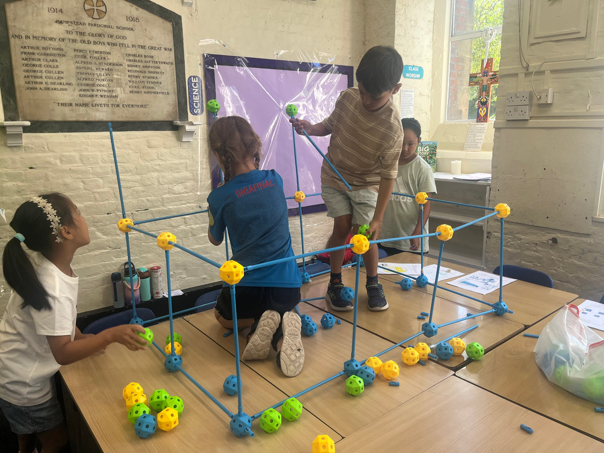 Children doing a hands-on STEAM activity at BetaGen's holiday coding camp in Hampstead